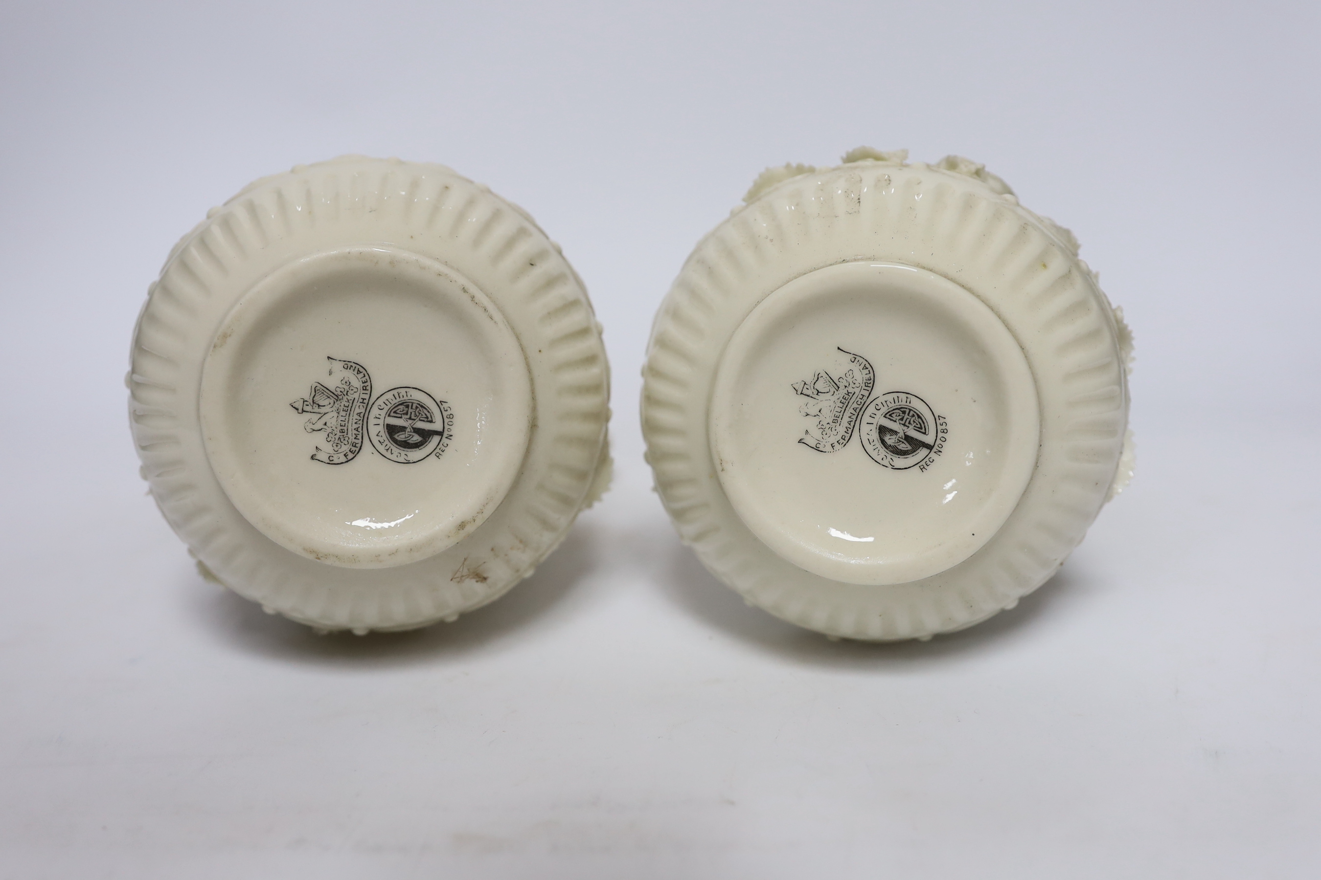 A pair of Belleek jugs with applied rose decoration, 19 cm high
